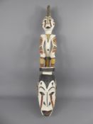 An Oceanic Mask, the mask has a plaited palm frond frame, carved of wood with natural pigments, upon