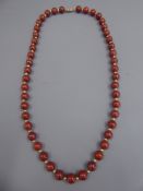 A Red Stone and Gold Metal Beaded Necklace, the necklace on 14k stamped clasp, approx 49 cms in