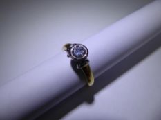 An 18 ct Yellow and White Gold Diamond Solitaire Ring, 50 pts dia size L, approx 5.4 gms.