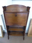 An Early 20th Century Oak Fall Front Book Case, the interior fitted with pigeon holes above two book