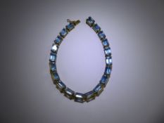 A Lady's 14ct Yellow Gold Aquamarine Tennis Bracelet, the bracelet set with twenty emerald cut