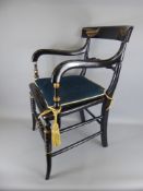Two Empire Style Ebonised Cane Seated Elbow Chairs. (2)