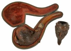 A Meerschaum pipe, early 20th century, carved in the form of a chicken's claw with silver band, in a