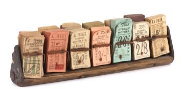 A collection of various coloured bus tickets in wooden stand. Dating from post-war, no later than