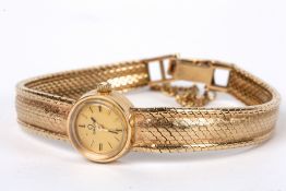 A ladies 9ct gold wind mechanism Omega bracelet watch, circa 1960 The small circular dial with baton