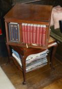 A mahogany revolving bookcase, mid 20th century the square top with four sections to hold books