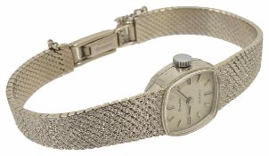 A 9ct white gold Bulova ladies bracelet wristwatch winding mechanism, the squared dial with baton