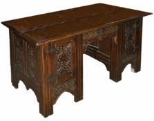 An oak carved knee hole desk, late 19th century of rectangular form with central drawer flanked by