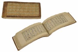 An interesting woven cloth and leather bound Islamic book The pages with Kufic script written in