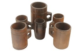 Four assorted wooden measures, late 19th century and later each with finger hole handle and with a