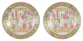 A pair of late 19th century Chinese famille rose plates each with central scene depicting