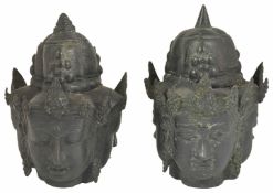 A pair of antique three sided bronze heads, possibly Tibetan the female heads with spiked helmets