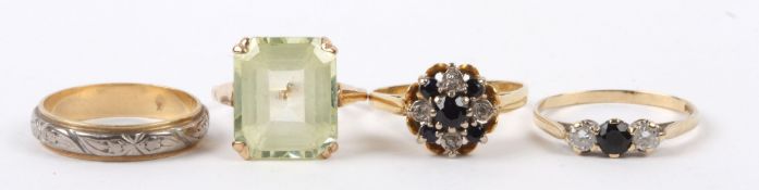 A large pale green rectangular cut gem set dress ring yellow metal mount (tests for gold), a