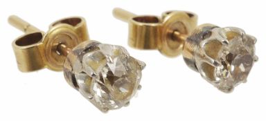 A pair of single stone diamond set stud earrings each stone approximately 0.25ct, yellow metal