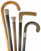 A collection of five walking sticks to include two ebonised horn handed walking sticks with silver
