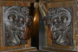 A pair of carved oak rams heads, 19th century each depicting a rams head upon a rectangular carved