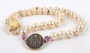 An unusual cultured pearl and coin necklace the pearls graduated to either side and set with a