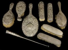A Victorian silver dressing table set, Birmingham 1898, comprising of two handled brushes, a hand
