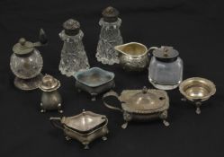 A collection of assorted silver and cut glass cruets comprising pepper grinder with turned wooden