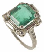 A good high Art Deco emerald and diamond set ring the central rectangular emerald of good colour