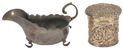 A George V silver sauce boat, Sheffield 1912 the shaped edge with scrolled handle and scrolled pad