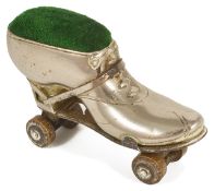 A ladies novelty Edwardian roller skate pin cushion the metal boot with heel and ribbon tie,