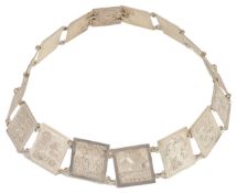 An Asian white metal repouse decorated panel belt each square high relief panel depicting