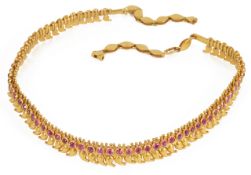 An attractive Indian gold and ruby set choker of fine boteh design fully articulated, the single