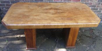 An Art Deco burr walnut dining table, of canted rectangular form with two rectangular sectioned