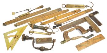 A collection of various carpenters tools, comprising of two set squares, two hand drills, two