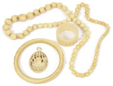 An early 20th century Chinese carved ivory pendant and bangle together with an ivory necklace and