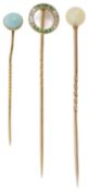 A delicate Edwardian emerald and diamond stick pin and two others, the emerald pin of circular