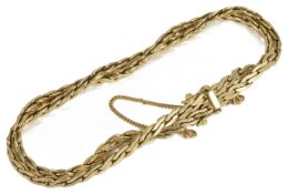 A Continental .585 gold flat weave twin chain bracelet the articulated chains twisted together and