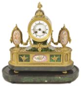 A French porcelain mounted ormolu mantle clock circa 1860 inset with simulated green stained