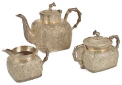 A good quality Chinese export ware white metal three piece tea set of squat square shaped form,