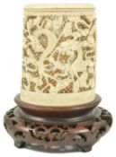 A Chinese 19th century carved ivory brush stand the cylindrical shaped holder carved with several