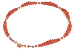 An attractive Edwardian natural coral woven bead necklace the woven bead sections spaced with