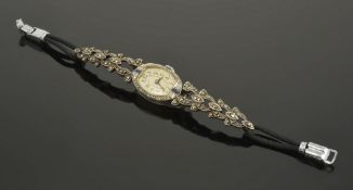 A Continental delicate sapphire and diamond set oval cocktail watch, circa 1910the white metal