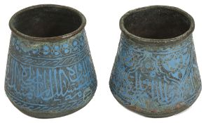 A pair of early Persian turquoise enamel on copper beakersof tapered squat form, each finely