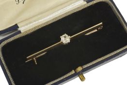 An early 20th century old cut diamond set bar broochthe single diamond mounted on a yellow metal