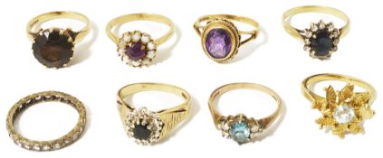 A collection of gold mounted contemporary dress ringsto include an amethyst and opal circular