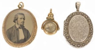 A large Victorian silver engraved hinged picture locket,together with a large Victorian double sided