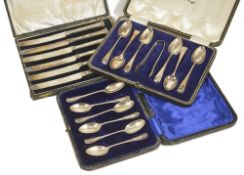 A selection of silver teaspoons, knives, silver bon bon dish, a Russian cream jugcomprising a