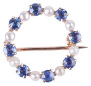 A delicate Continental small pearl and sapphire set circle brooch