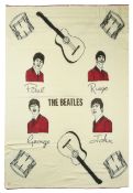 A Witney 'Beatles' blanket, illustrated with images of the four Beatles, with red wool needle work e