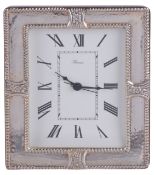 A modern clock with silver frame