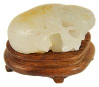 An antique Chinese white/grey and russet jade carving of a cat