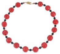 A reproduction Chinese red lacquer bead necklace,