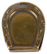 A brass vesta in the form of a horse shoe