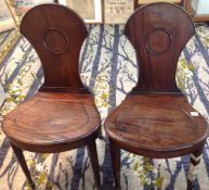 A pair of Victorian mahogany hall chairs